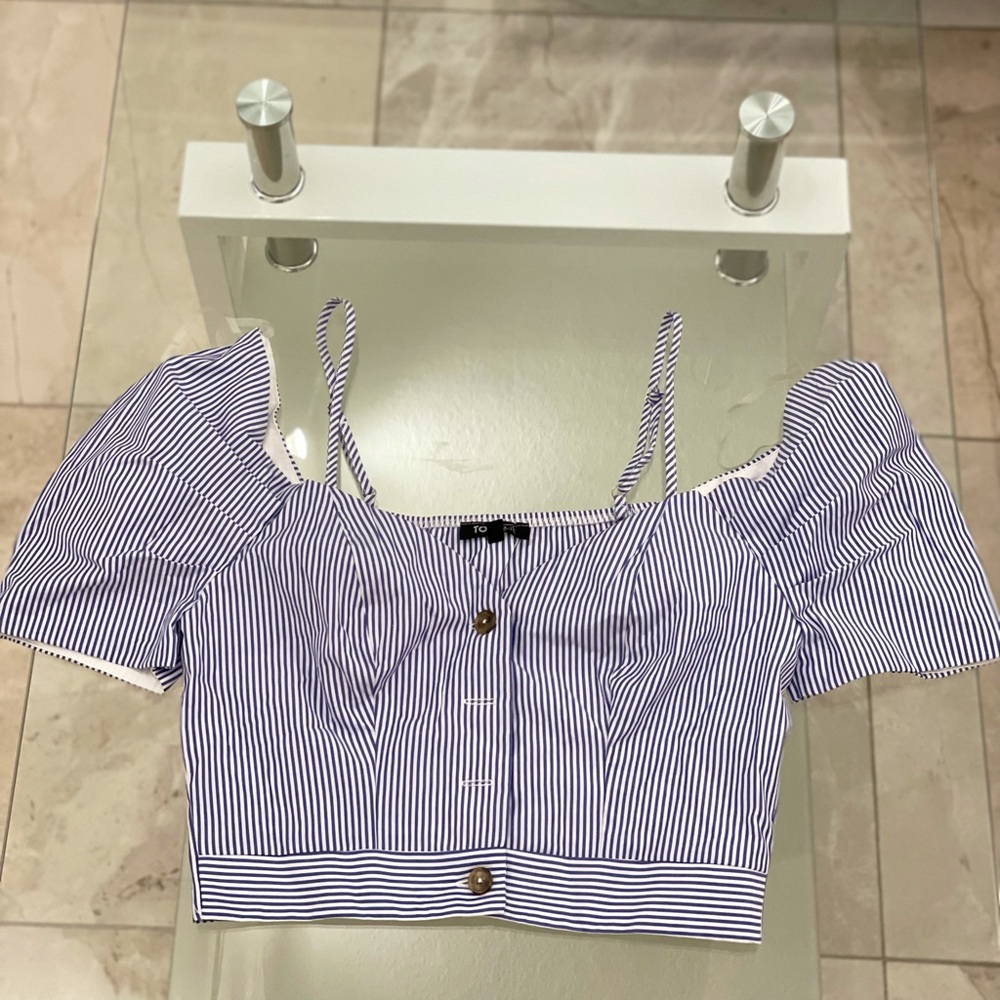 Crop top, blue with white lines.